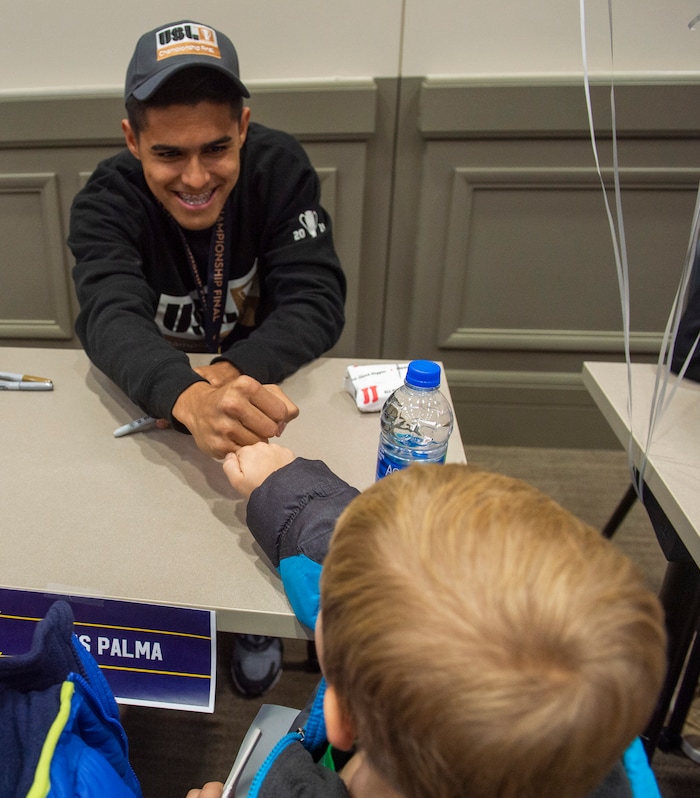 (Rick Egan  |  The Salt Lake Tribune)    Jackson Barlocker, 7, from Herriman  gets a fist bump from Real Monarchs  Luis Palma  as the Monarchs celebrate their USL Cup Championship, during their championship parade at Lynn Crane Park in Herriman, Wednesday, Nov. 20, 2019.