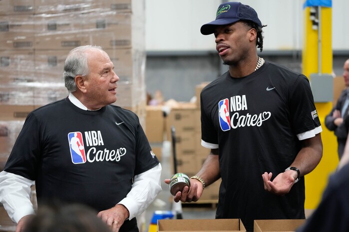 (Francisco Kjolseth | The Salt Lake Tribune) Apostle Ronald A. Rasband and Buddy Hield from the Indiana Pacers pack boxes with food during the NBA Cares Day of Service in Salt Lake City on Feb. 17, 2023.
