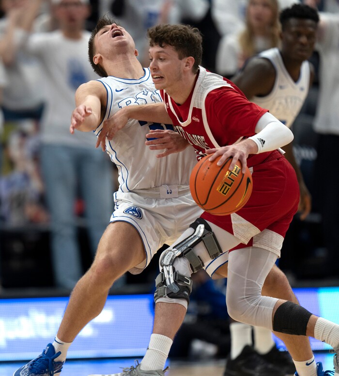 (Rick Egan | The Salt Lake Tribune)  South Dakota Coyotes guard A.J. Plitzuweit (10) collides with Brigham Young Cougars guard Dallin Hall (30), in basketball action between the Brigham Young Cougars and the South Dakota Coyotes, at Vivint Arena, in Salt Lake City, on Saturday, Dec. 3, 2022.