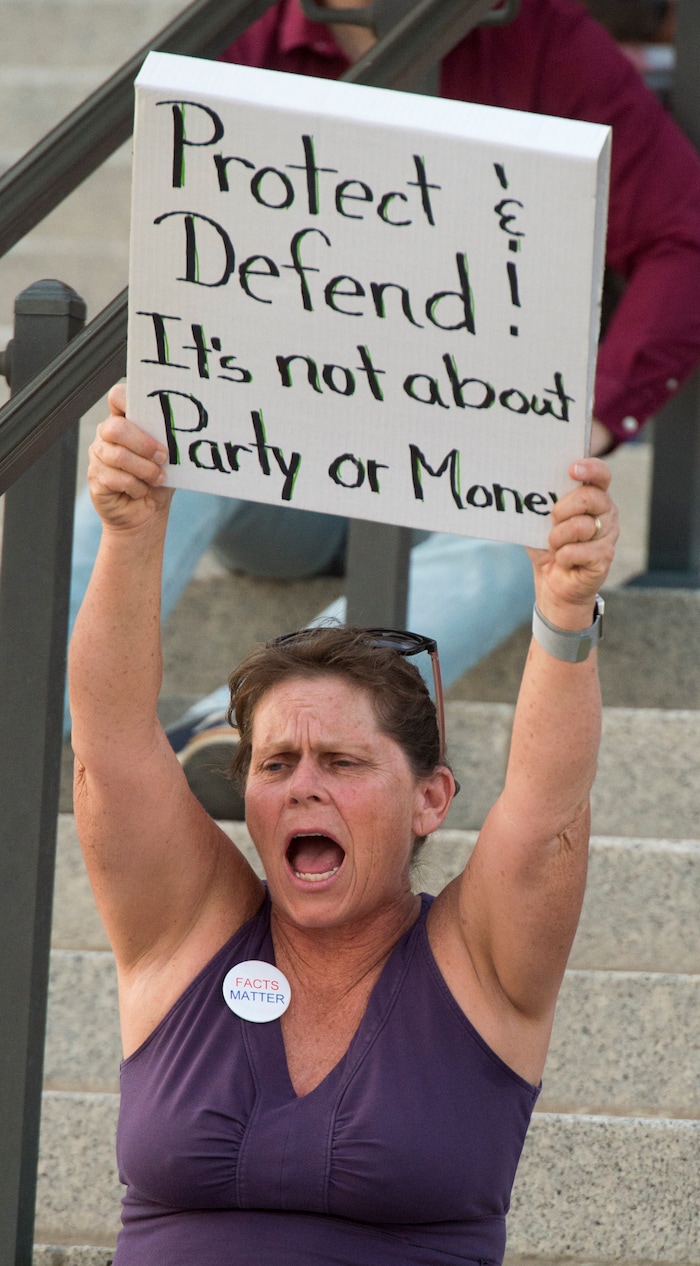 (Rick Egan  |  The Salt Lake Tribune)     Sara Willard from Sandy, joins in a chant at the Confront Corruption:Demand Democracy vigil on the steps of the Utah State Capitol, Wednesday. Salt Lake City joined more than 110 vigils nationwide to stand against corruption in the United States, July 18, 2018.