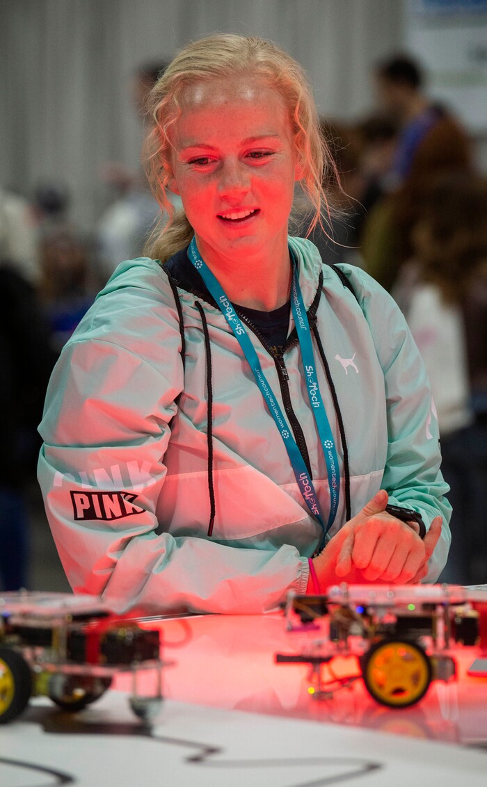 (Rick Egan  |  The Salt Lake Tribune)         Emma Newby, from Mountain View High,  checks out the robotic cars at the SheTech Explorer Day event, at the Mountain America Expo Center in Sandy, Tuesday, April 9, 2019.