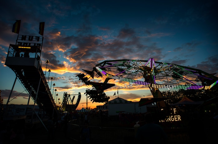 (Rick Egan  |  The Salt Lake Tribune)   The Midway at the Utah State Fair lights up as the sunsets, Monday, Sept. 10, 2018.