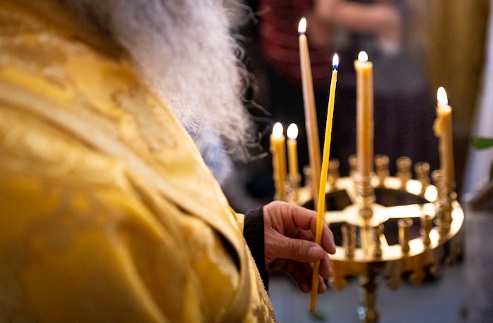 (Isaac Hale | Special to The Tribune) A clergy member holds a candle during a consecration service for St. Xenia Orthodox Church in Payson on Saturday, July 16, 2022.