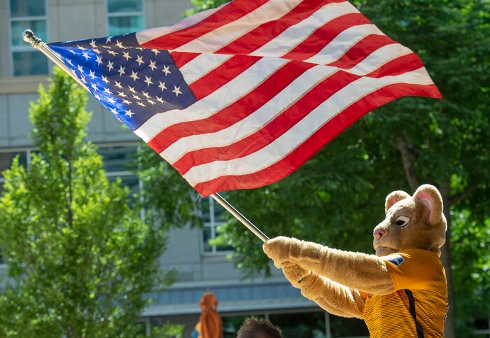 (Rick Egan  |  The Salt Lake Tribune)   Cleo the  Royals Lioness mascot waves the flag, as the crowd celebrates the US women's team 2-0 defeat of the Netherlands in the World Cup final, during a watch party at the Gallivan Center in Salt Lake, Sunday, July 7, 2019.