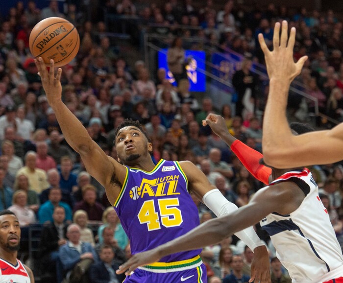 (Rick Egan  |  The Salt Lake Tribune)        Utah Jazz guard Donovan Mitchell (45) takes the ball to the hoop, as Washington Wizards forward Bobby Portis (5) defends, in NBA action between the Utah Jazz and the Washington Wizards, in Salt Lake City, Friday, March 29, 2019.