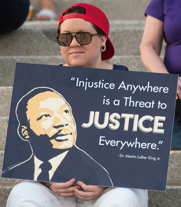 (Rick Egan  |  The Salt Lake Tribune)     Kylee Howell holds a sign at the Confront Corruption:Demand Democracy vigil on the steps of the Utah State Capitol, Wednesday. Salt Lake City joined more than 110 vigils nationwide to stand against corruption in the United States, July 18, 2018.