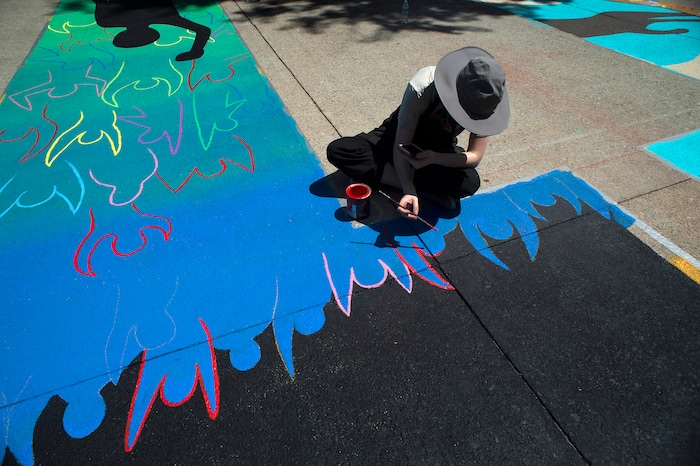 (Rick Egan  |  The Salt Lake Tribune)     Veronica Zac paints the letter ÒTÓ in the Black Lives Matter mural, on the south side of City Hall on Tuesday, Aug. 4, 2020.