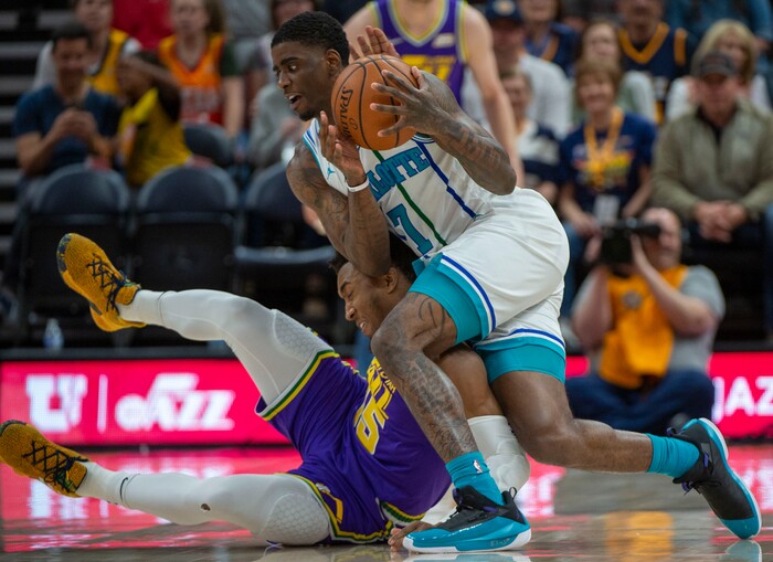 (Rick Egan  |  The Salt Lake Tribune)   Utah Jazz guard Donovan Mitchell (45) goes for a loose ball along with Charlotte Hornets guard Dwayne Bacon (7), in NBA action between the Utah Jazz and the Charlotte Hornets, in Salt Lake City,  Monday, April 1, 2019.
