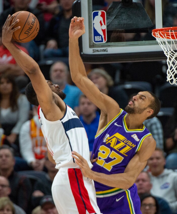(Rick Egan  |  The Salt Lake Tribune)        Washington Wizards forward Jabari Parker (12) goes in for a slam dunk, as Utah Jazz center Rudy Gobert (27) defends, in NBA action between the Utah Jazz and the Washington Wizards, in Salt Lake City, Friday, March 29, 2019.