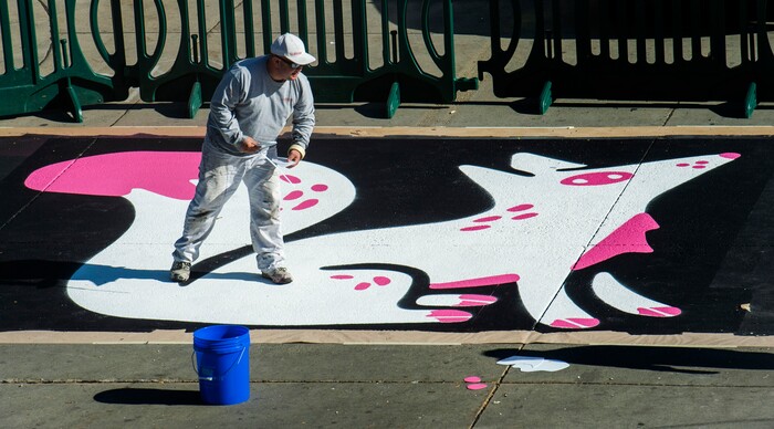 (Rick Egan | The Salt Lake Tribune). Workers paint the crosswalk at the intersection of 100 South and Rio Grande Street, on Wednesday, Nov. 4, 2020.