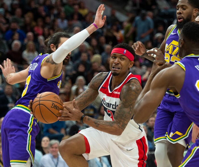 (Rick Egan  |  The Salt Lake Tribune)        Washington Wizards guard Bradley Beal (3) splits the Jazz defenders, in NBA action between the Utah Jazz and the Washington Wizards, in Salt Lake City, Friday, March 29, 2019.