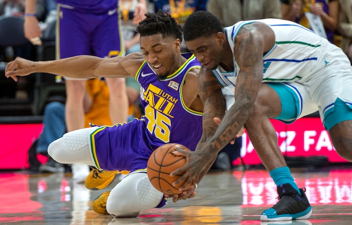 (Rick Egan  |  The Salt Lake Tribune)   Utah Jazz guard Donovan Mitchell (45) goes for a loose ball along with Charlotte Hornets guard Dwayne Bacon (7), in NBA action between the Utah Jazz and the Charlotte Hornets, in Salt Lake City,  Monday, April 1, 2019.