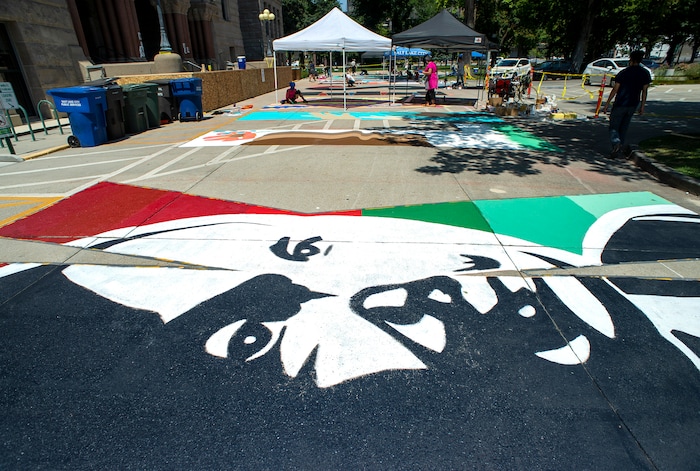 (Rick Egan  |  The Salt Lake Tribune)    Artists paint a Black Lives Matter mural, on the south side of Salt Lake City Hall on Tuesday, Aug. 4, 2020.