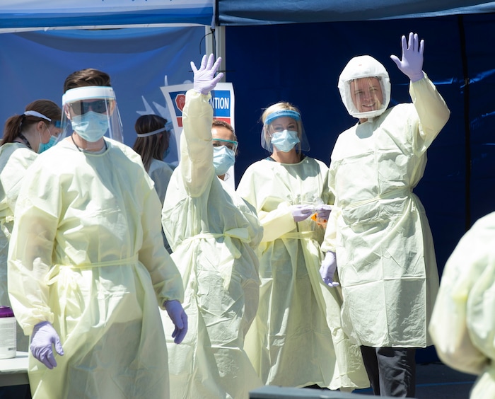 (Rick Egan  |  The Salt Lake Tribune)   Medical assists motion that they are ready for the next patient, at the Intermountain Healthcare Coronavirus Mobile Testing Unit at Utah Valley Hospital in Provo, Friday May 8, 2020.