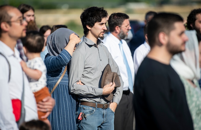 (Isaac Hale | Special to The Tribune) Elijah Bachrach listens with his wife, Christine Lan Ha Bachrach, during a consecration service for St. Xenia Orthodox Church in Payson on Saturday, July 16, 2022.
