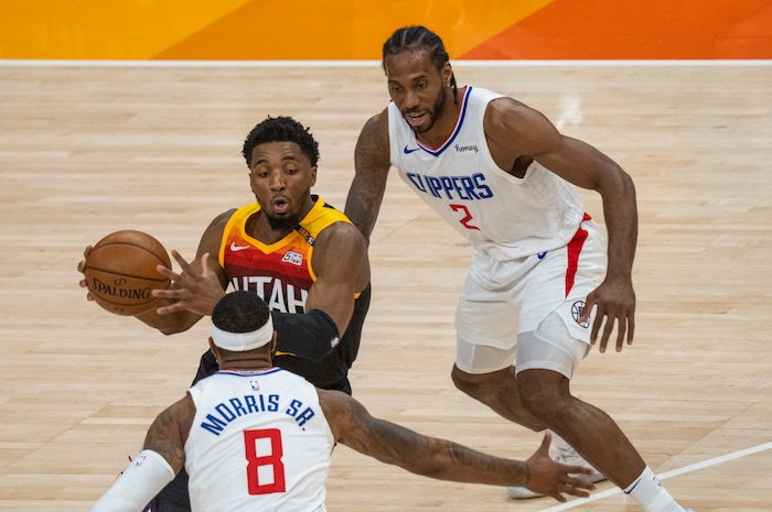 (Rick Egan | The Salt Lake Tribune) Donovan Mitchell (45) splits the LA defenders, forward Kawhi Leonard (2)] and Clippers forward Marcus Morris Sr. (8) to score for the Jazz, in NBA action between the Utah Jazz and the LA Clippers, in game one in the second round of the NBA playoff series at Vivint Arena, on Tuesday, June 8, 2021.