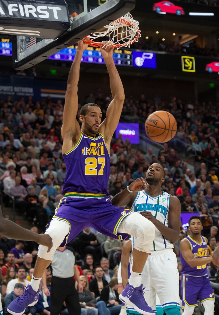 (Rick Egan  |  The Salt Lake Tribune)   Utah Jazz center Rudy Gobert (27) dunks the ball on an ally-oop from Utah Jazz guard Ricky Rubio (3) , in NBA action between the Utah Jazz and the Charlotte Hornets, in Salt Lake City,  Monday, April 1, 2019.