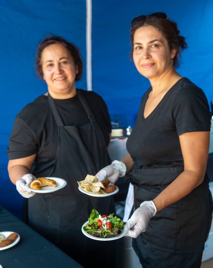 (Rick Egan  |  The Salt Lake Tribune)     Sister Chefs Suha and Mayada prepare traditional middle eastern cuisine at their Zaater and Zayton booth at the Gallivan Center, as Salt Lake City's Spice Kitchen Incubator program serves a variety of international cuisine at the welcome party for the United Nations Civil Society Conference, Sunday, Aug. 25, 2019.