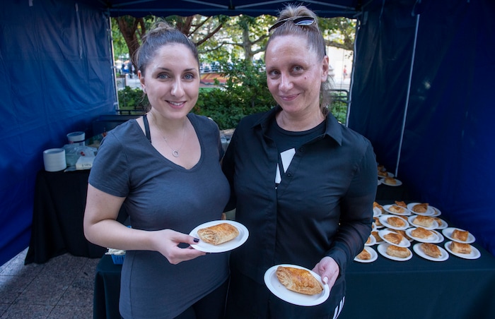 (Rick Egan  |  The Salt Lake Tribune)     Milena (left) and her mother Karine, serve  Eastern European cuisine from their Spudnik booth at the Gallivan Center, as Salt Lake City's Spice Kitchen Incubator program serves a variety of international cuisine at the welcome party for the United Nations Civil Society Conference, Sunday, Aug. 25, 2019.