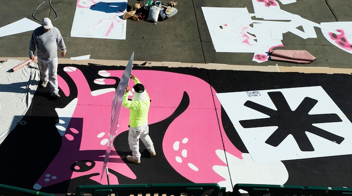 (Rick Egan | The Salt Lake Tribune). Workers paint the crosswalk at the intersection of 100 South and Rio Grande Street, on Wednesday, Nov. 4, 2020.