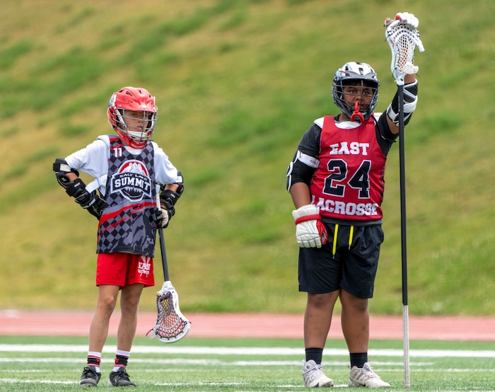 (Rick Egan | The Salt Lake Tribune)  11 and Edward Tonga watch the action as they wait their turn, during East youth lacrosse practice, on Wednesday, June 22, 2022.