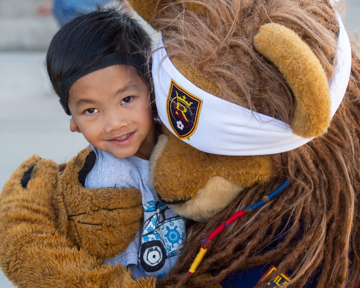 (Rick Egan | The Salt Lake Tribune) Conlan Pugh, 6 gets a hug from Real Salt Lake mascot Leo the Lion on the first day of school at Copperview Elementary School in Midvale, Monday, Aug. 19, 2019.