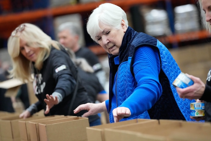 (Francisco Kjolseth | The Salt Lake Tribune) Former Utah Jazz owner Gail Miller helps pack boxes with food during the NBA Cares Day of Service in Salt Lake City on Feb. 17, 2023.
