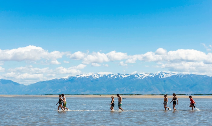 (Rick Egan  |  The Salt Lake Tribune)       Participants brave the cold temperature as they venture out into the water at the Great Salt Lake Saturday, June 8, 2019.  The cool temperatures resulted in crowd of around 300 people, so the attempt to break the world record was turned into a polar plunge.