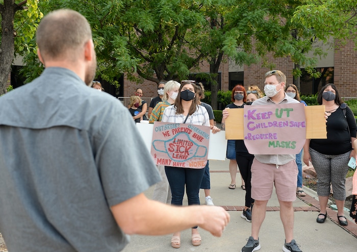 (Chris Samuels | The Salt Lake Tribune) People listen to organizer Chris Phillips speak at a rally advocating mask use in schools outside the Utah Board of Education building, Friday, Aug. 6, 2021.